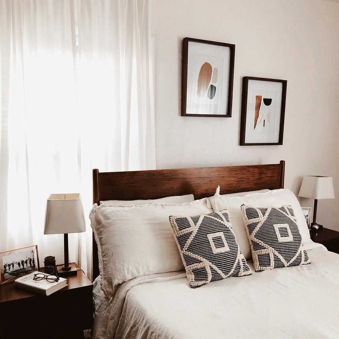 A Bed With White Sheets And Two Framed Pictures On The Wall pertaining to Alton Cherry Ii Queen Wood Platform Bed & Headboard 3 Piece Bedroom Set With 2 Nightstands