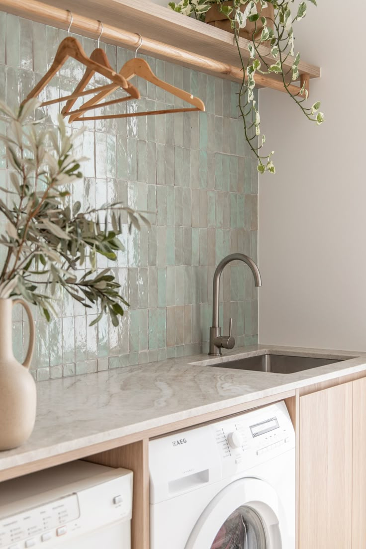 A Washer And Dryer In A Kitchen With Green Tiles On The Wall Behind It intended for